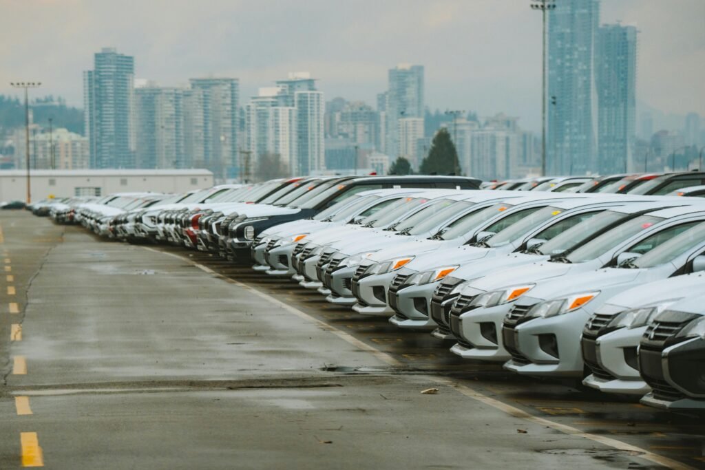 Line of white cars parked in parking lot. rent a car in Rome