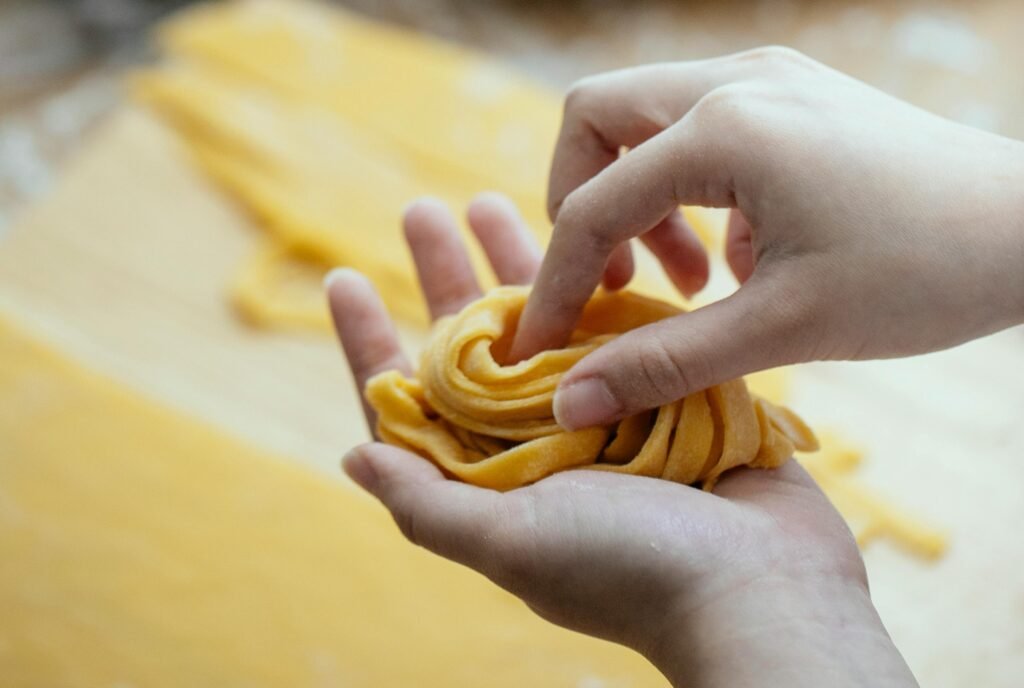 Woman making homemade pasta with egg dough