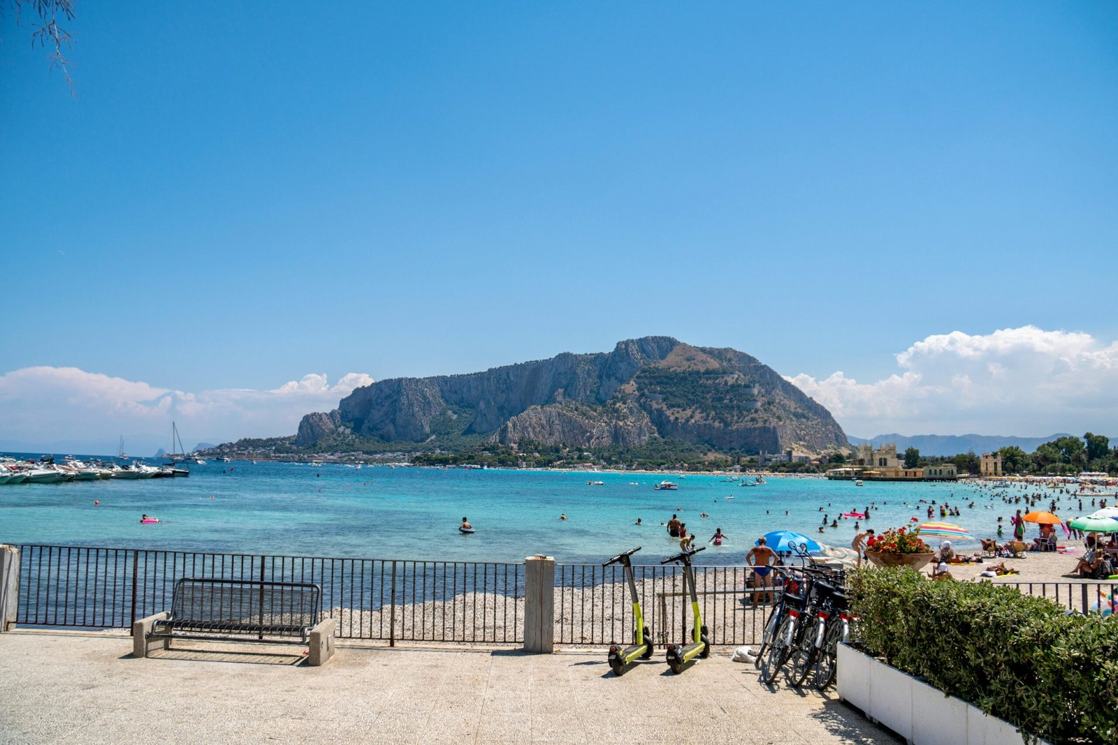 People on Swimming on the Beach Near the Mountain