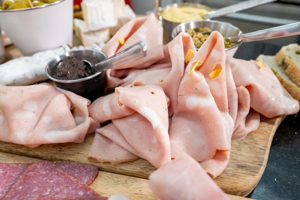 Close-up of Mortadella an Sauces on a Wooden Board