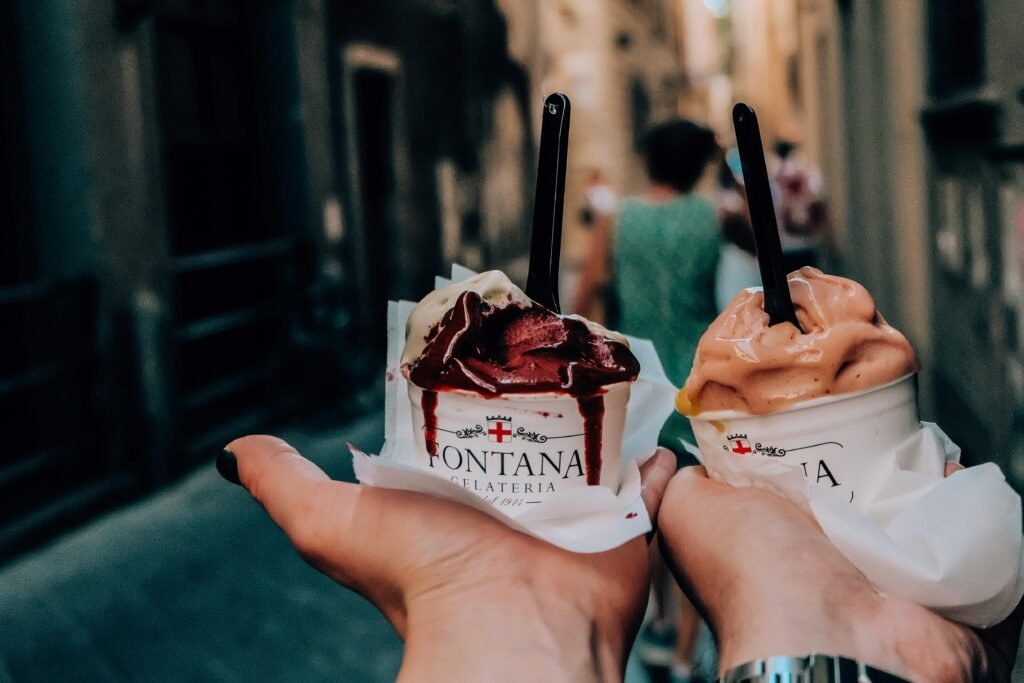 Melting ice cream in hands of tourists